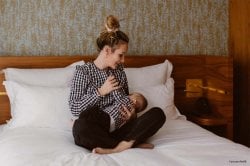 Maman moderne choisissant entre l'allaitement et le biberon pour son nourrisson, réflexion intime sur l'alimentation infantile et les bienfaits de l'allaitement maternel versus formule lactée en poudre.